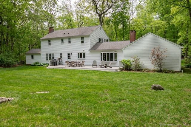7 Indian Trl, Woodbridge, CT 06525 - rear view of house featuring a chimney, roof with shingles, and a lawn