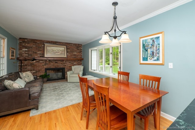 7 Indian Trl, Woodbridge, CT 06525 - dining room with light wood-style flooring, crown molding, and a brick fireplace