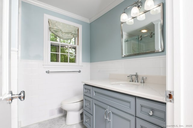 7 Indian Trl, Woodbridge, CT 06525 - bathroom featuring tile walls, toilet, vanity, ornamental molding, and a shower with door