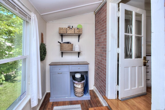 detailed view of wood finished floors and brick wall
