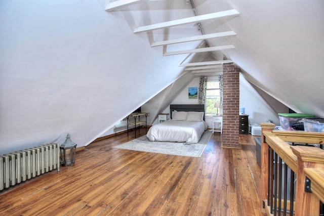 bedroom with radiator heating unit and hardwood / wood-style floors