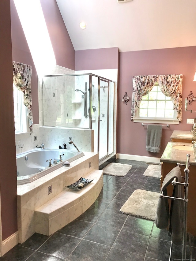 full bathroom featuring a tub with jets, a shower stall, baseboards, vanity, and vaulted ceiling