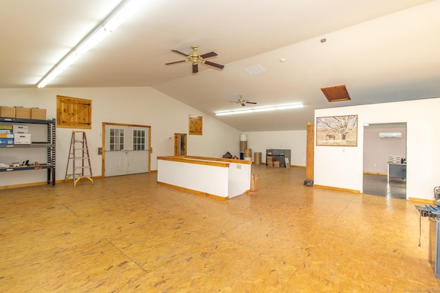 unfurnished living room featuring vaulted ceiling, a ceiling fan, baseboards, and an AC wall unit
