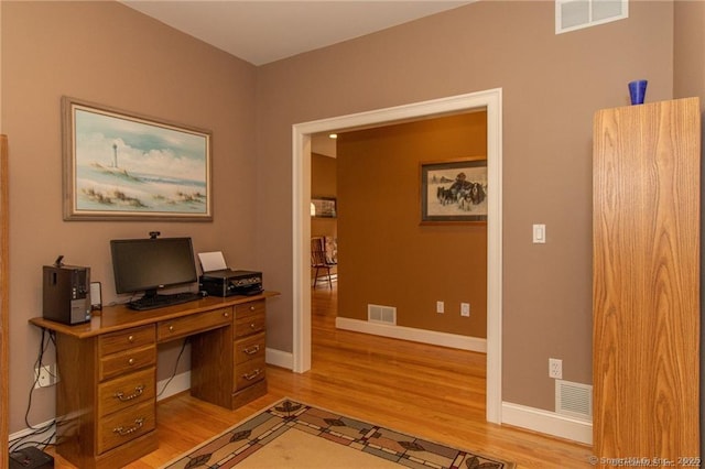 office space with light wood-style flooring and baseboards