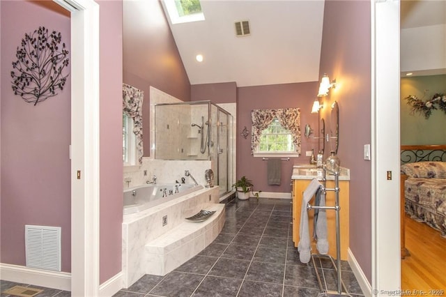 bathroom featuring a shower stall, a bath, lofted ceiling, baseboards, and a skylight