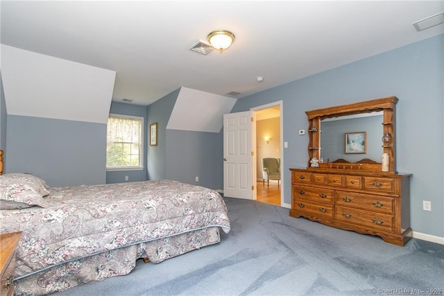 carpeted bedroom with vaulted ceiling and baseboards