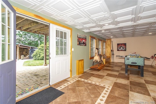 entryway with tile patterned floors and an ornate ceiling