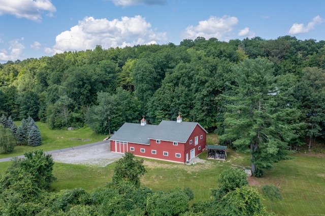 view of subject property featuring a heavily wooded area