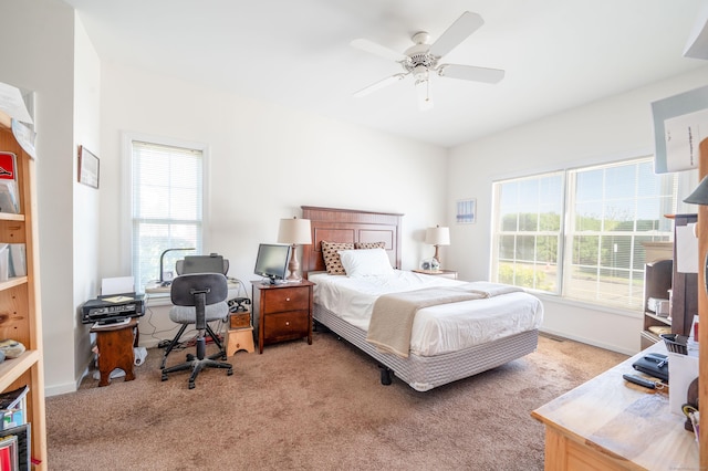 bedroom with light carpet and a ceiling fan