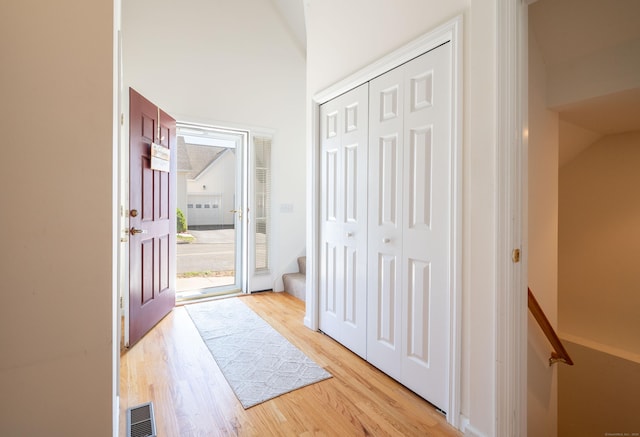 foyer entrance featuring light wood-style flooring and stairs