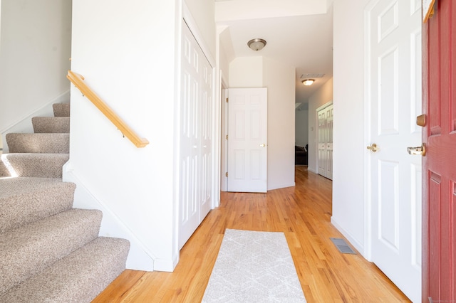 foyer with light wood-style flooring and stairway