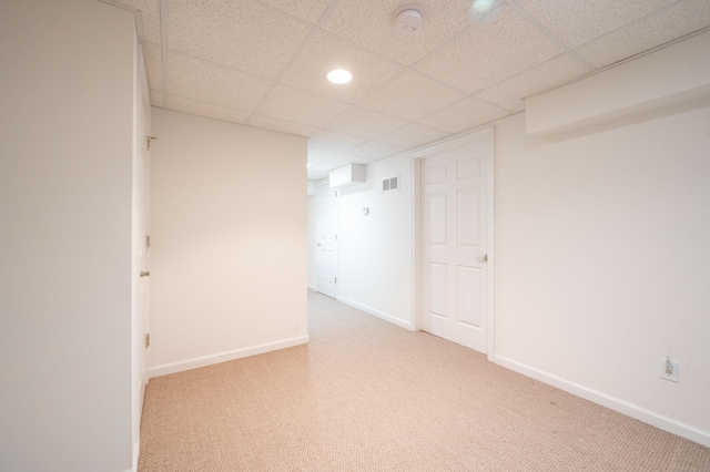 carpeted spare room featuring a paneled ceiling, baseboards, recessed lighting, and a smoke detector