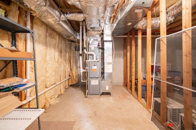 unfinished below grade area featuring heating unit