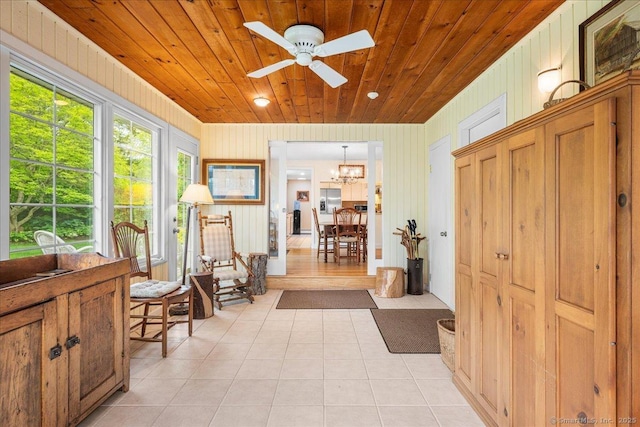 42 N Main St, Essex, CT 06426 - foyer with light tile patterned floors, ceiling fan, wood ceiling, a chandelier, and wood walls