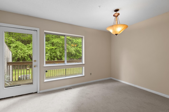 carpeted empty room with baseboards