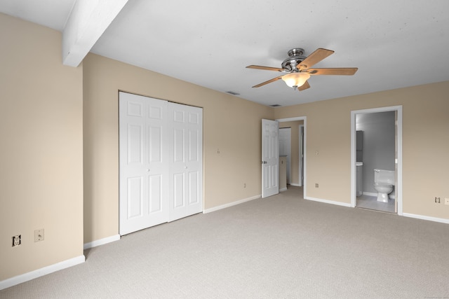 unfurnished bedroom with light colored carpet, baseboards, a closet, and a ceiling fan