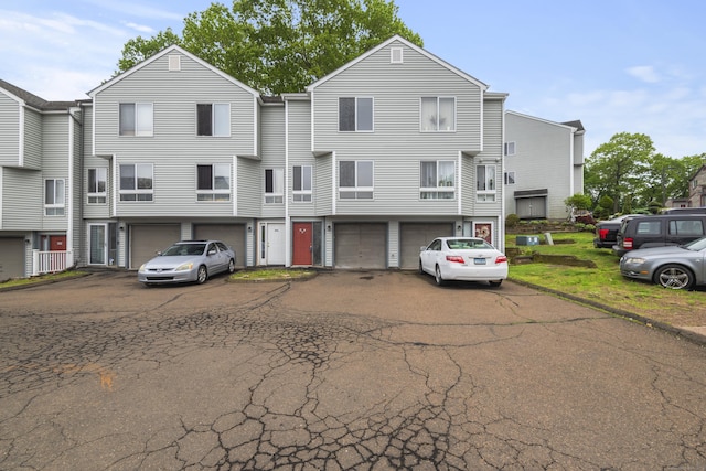 townhome / multi-family property featuring a garage and driveway