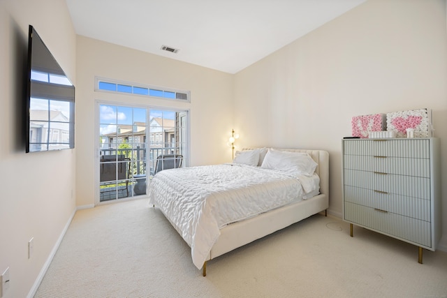 bedroom with baseboards, light carpet, and access to exterior
