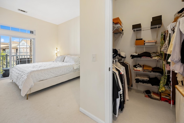 carpeted bedroom with baseboards and a closet