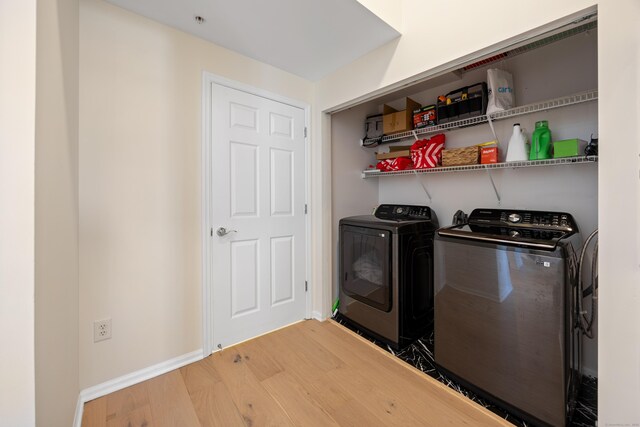 laundry room featuring separate washer and dryer, wood finished floors, and baseboards
