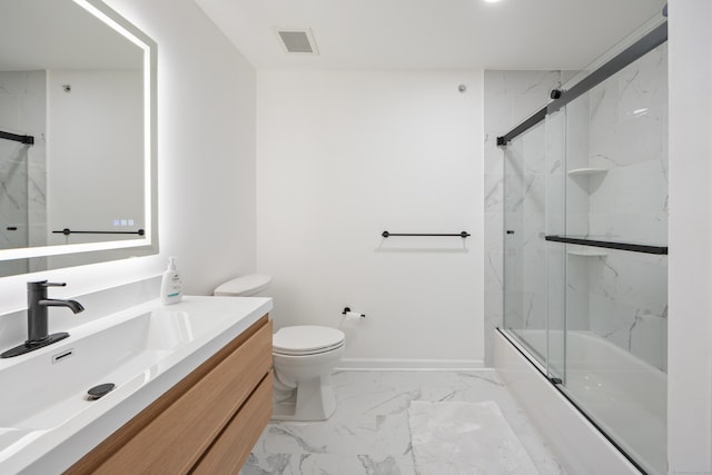 full bath with marble finish flooring, toilet, vanity, shower / bath combination with glass door, and baseboards