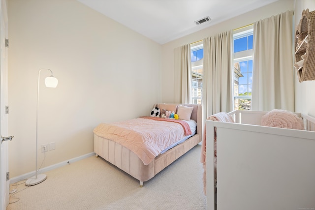 bedroom with light carpet and baseboards