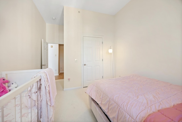 bedroom with light carpet and baseboards