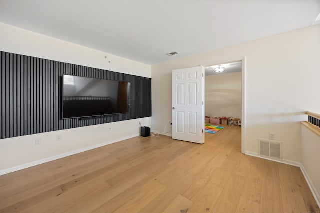 unfurnished living room with light wood-style floors and baseboards