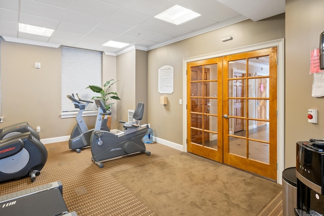 exercise area with french doors, carpet, baseboards, and crown molding