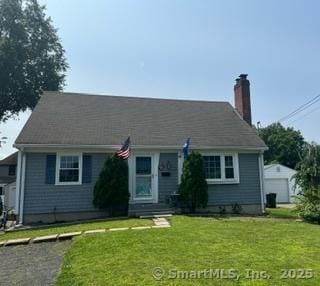 65 Dale Rd, Wethersfield, CT 06109 - view of front facade with a chimney and a front yard