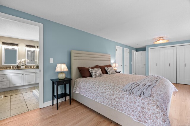 17 Fernridge Rd, West Hartford, CT 06107 - bedroom with light wood-style flooring, connected bathroom, and baseboards