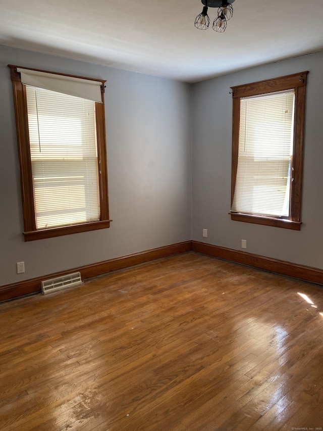 29 Cabot St, New Britain, CT 06053 - spare room with hardwood / wood-style floors, baseboards, and a chandelier