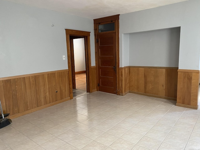 29 Cabot St, New Britain, CT 06053 - spare room featuring wainscoting, wood walls, and light tile patterned floors