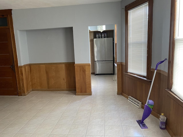 29 Cabot St, New Britain, CT 06053 - empty room featuring wainscoting, wood walls, and light tile patterned flooring