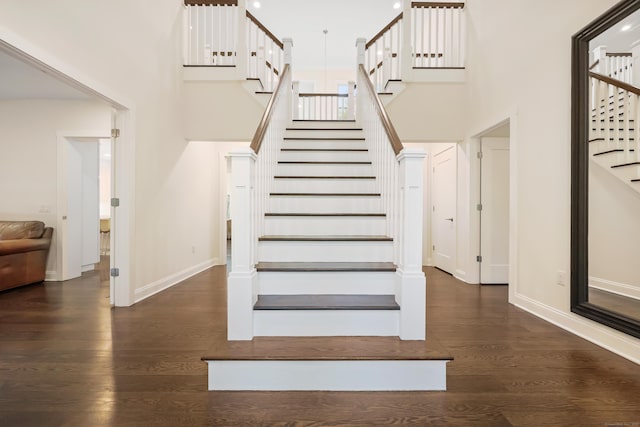 43 Hunting Ridge Rd, Greenwich, CT 06831 - stairs featuring a high ceiling, wood finished floors, and baseboards