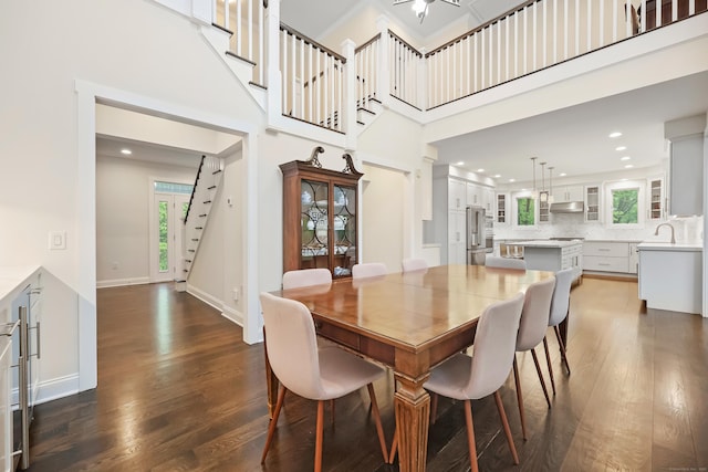 43 Hunting Ridge Rd, Greenwich, CT 06831 - dining area with dark wood-type flooring, stairway, recessed lighting, a high ceiling, and baseboards