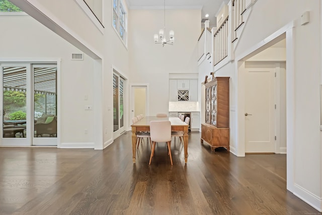 43 Hunting Ridge Rd, Greenwich, CT 06831 - dining room with a chandelier, baseboards, dark wood-style flooring, and a towering ceiling