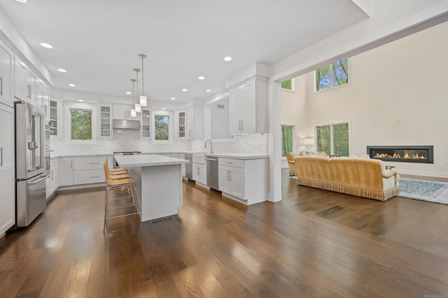 43 Hunting Ridge Rd, Greenwich, CT 06831 - kitchen featuring stainless steel appliances, open floor plan, tasteful backsplash, glass insert cabinets, and a sink