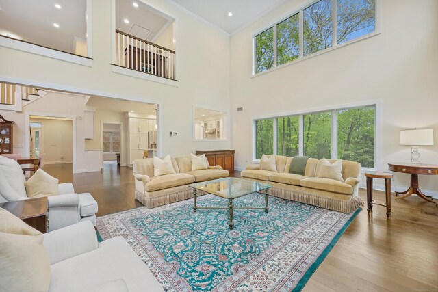 43 Hunting Ridge Rd, Greenwich, CT 06831 - living area with healthy amount of natural light, wood finished floors, ornamental molding, a towering ceiling, and baseboards