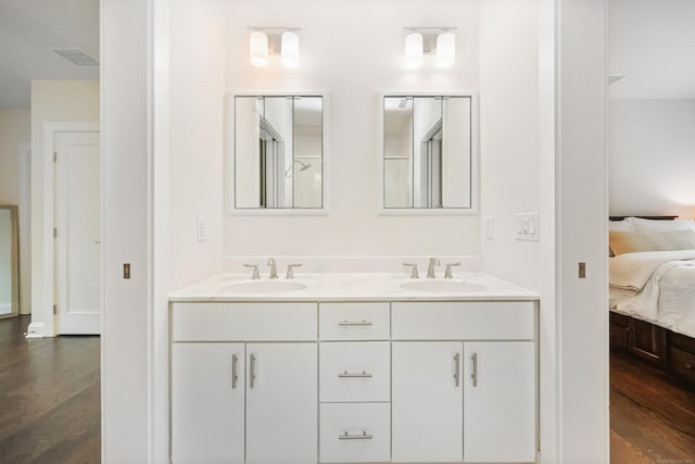 43 Hunting Ridge Rd, Greenwich, CT 06831 - bathroom with connected bathroom, wood finished floors, and double vanity