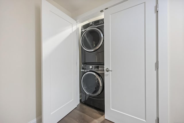 43 Hunting Ridge Rd, Greenwich, CT 06831 - laundry room with stacked washing machine and dryer and dark wood-style flooring