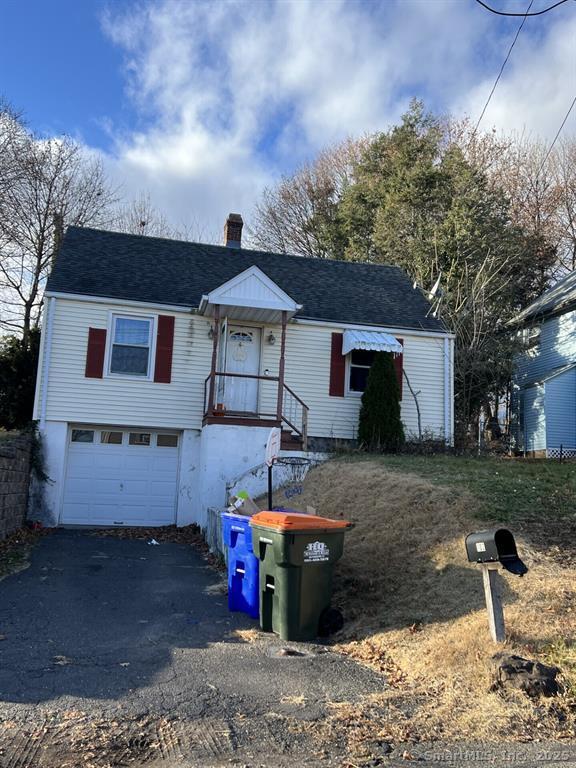 102 Horton Ave, Meriden, CT 06450 - view of front of property with asphalt driveway, a chimney, an attached garage, and roof with shingles