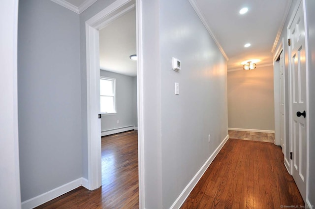 hall with a baseboard heating unit, crown molding, wood finished floors, baseboards, and recessed lighting