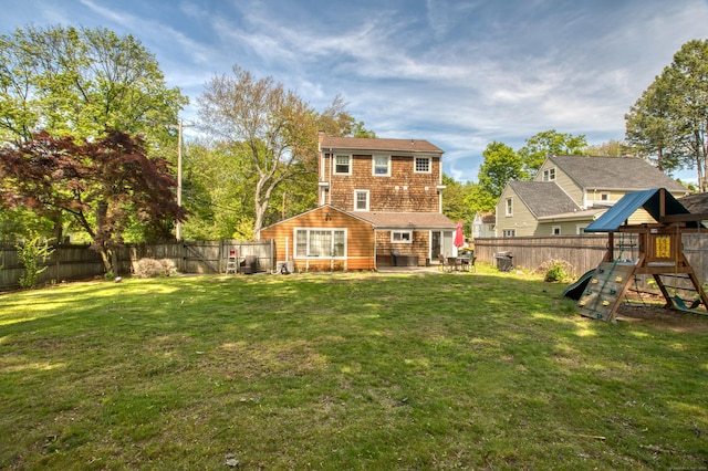 back of property featuring a playground, a patio, and a chimney