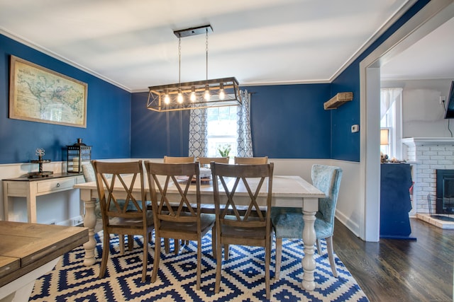 dining area with ornamental molding and wood finished floors