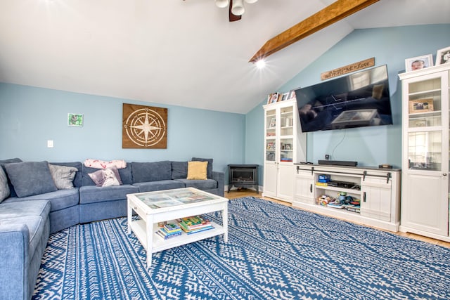 living area with a wood stove and a ceiling fan