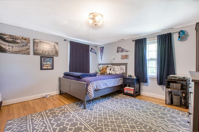 bedroom with wood finished floors and baseboards