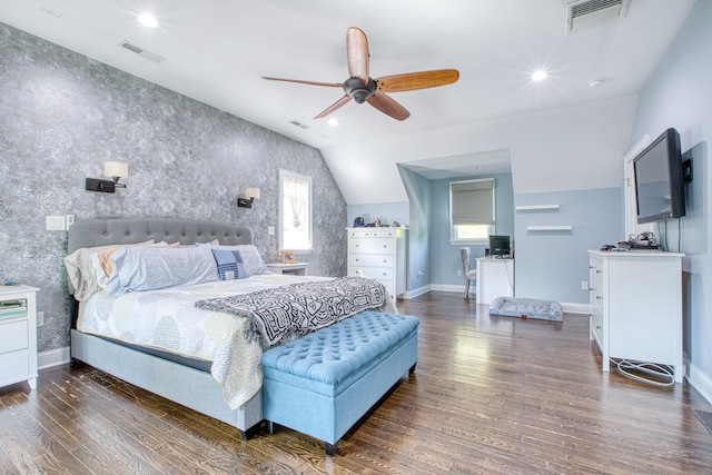 bedroom with an accent wall, wood finished floors, lofted ceiling, baseboards, and wallpapered walls