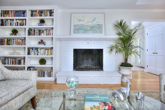 81 Grumman Hill Rd, Wilton, CT 06897 - living area with wood finished floors, crown molding, and a brick fireplace