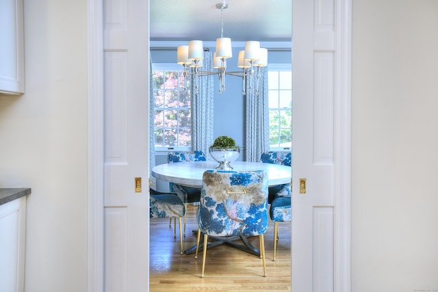 81 Grumman Hill Rd, Wilton, CT 06897 - dining area featuring a chandelier, wood finished floors, plenty of natural light, and crown molding